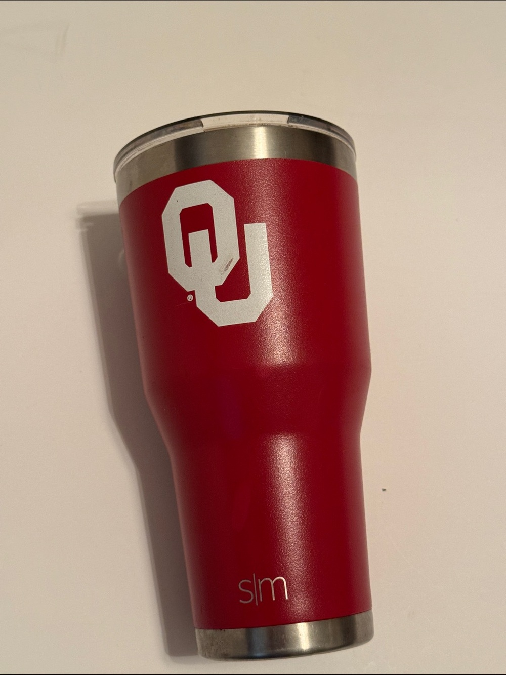 Oklahoma Sooners metal drink container with plastic sip lid.